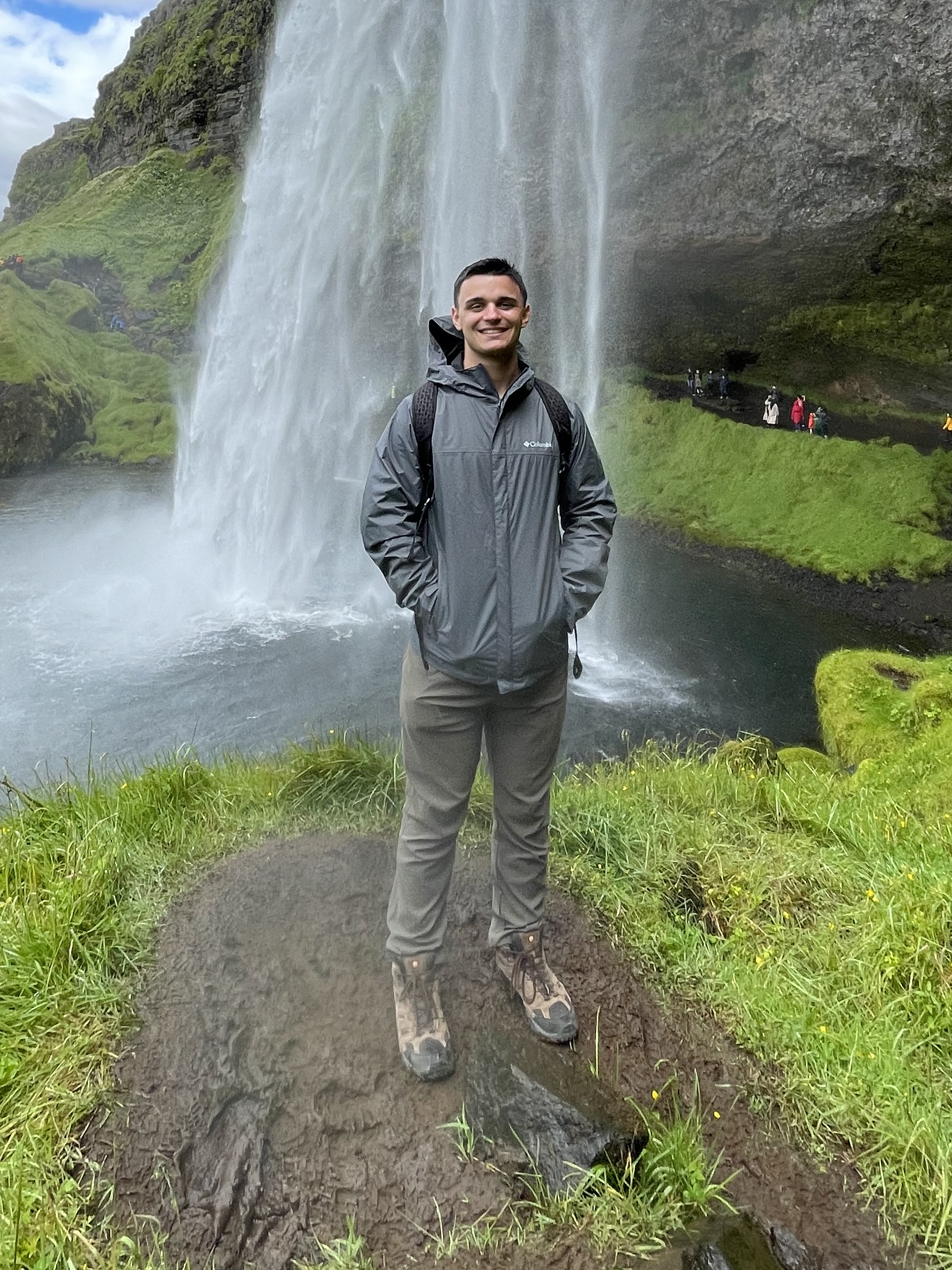 Joseph standing beside a waterfall